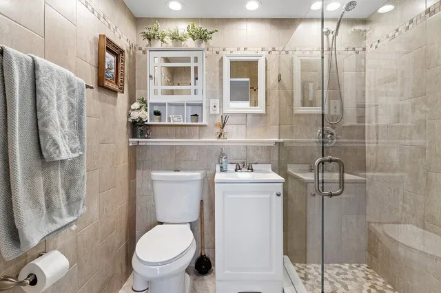 a bathroom with a toilet sink and shower