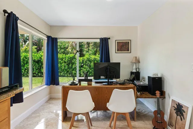a work room with furniture and a flat screen tv