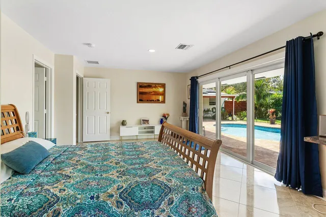 a bedroom with furniture and large window