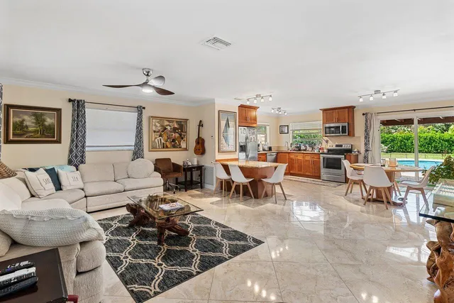 a living room with furniture a rug and a large window