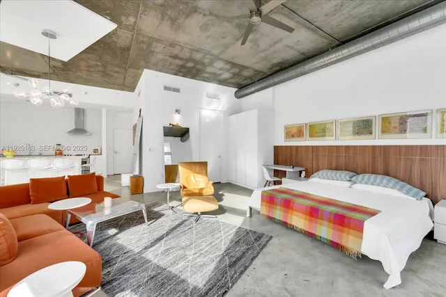 a bed room with a bed furniture and a couch