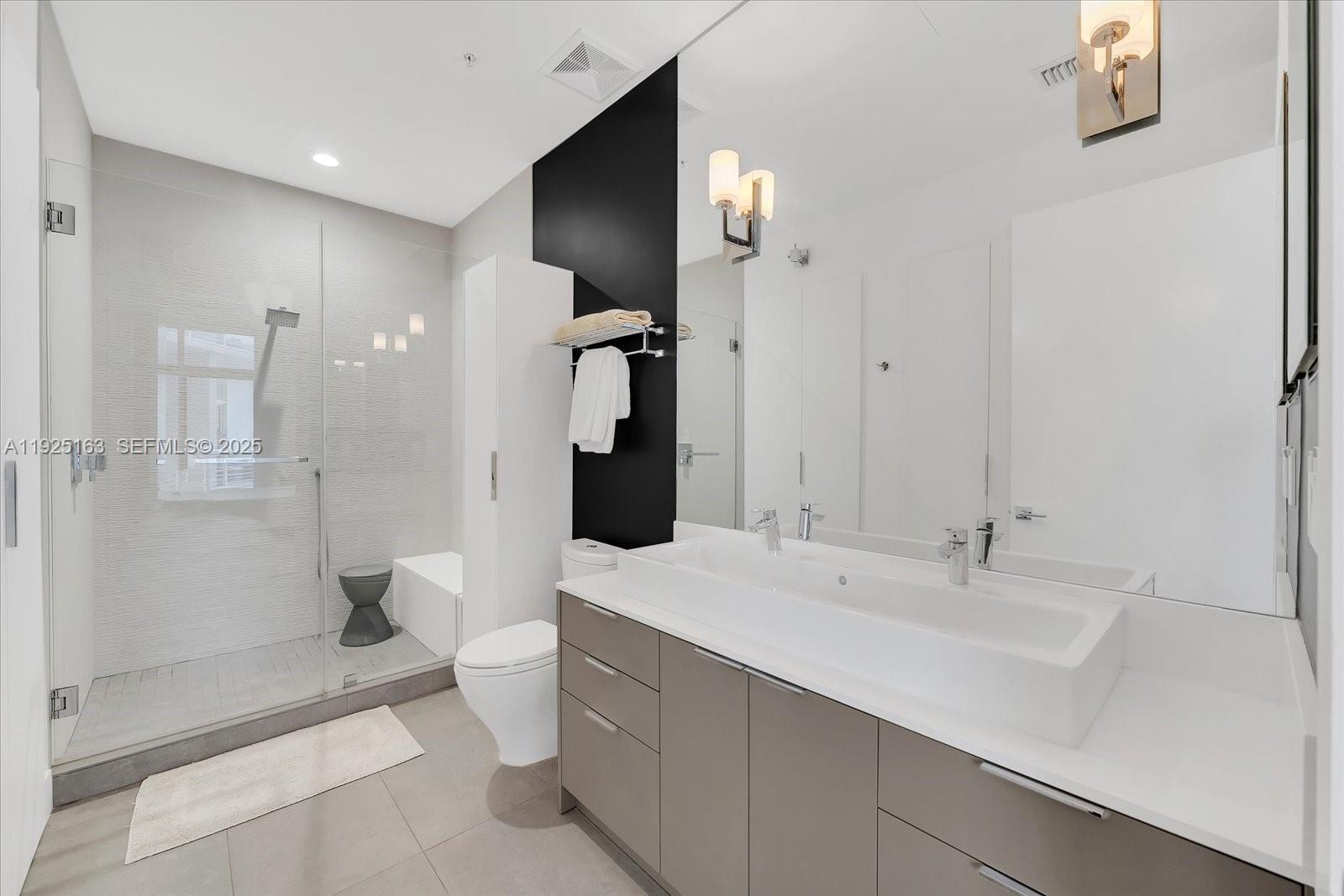 2001 Meridian Avenue, Unit 510 Miami Beach, FL 33139 - Photo 10 of 16 a bathroom with a sink a toilet and shower