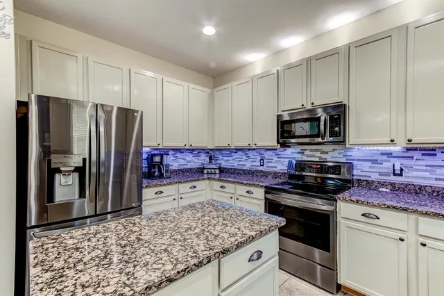 a kitchen with a sink stove and refrigerator