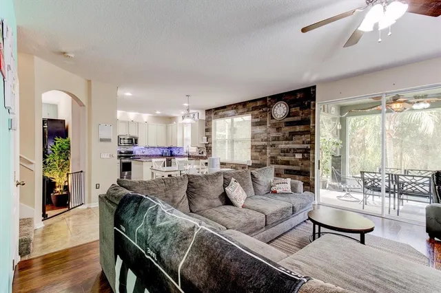 a living room with furniture ceiling fan and a rug