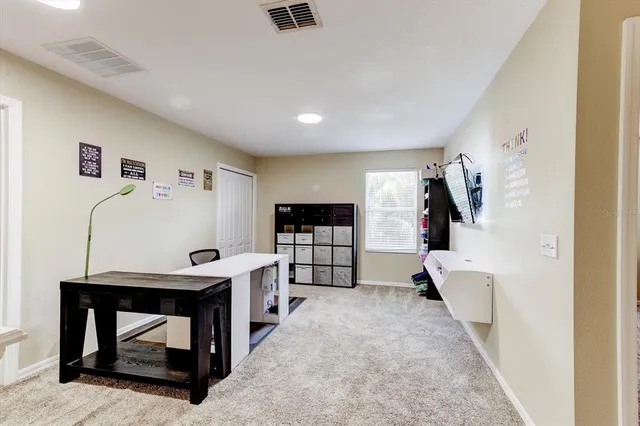 a bedroom with a bed and a chandelier fan