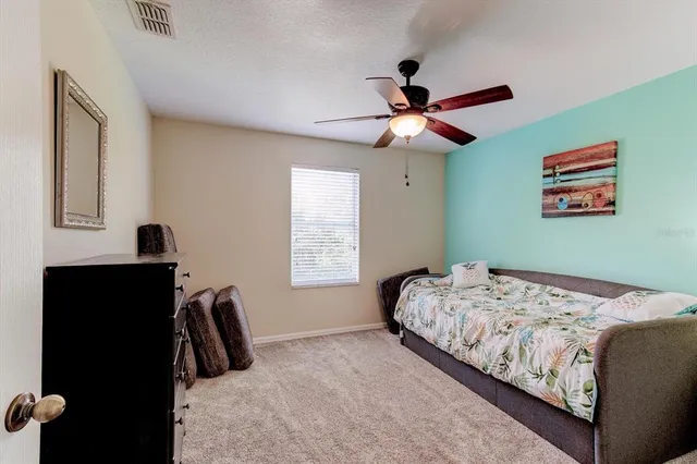 a bedroom with furniture and a wooden floor