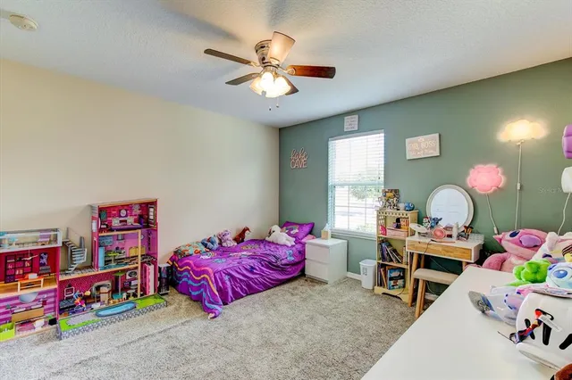a spacious bedroom with a bed a dresser and a book shelf