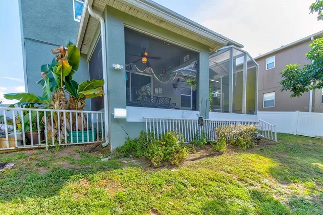 an aerial view of a house with swimming pool patio and outdoor seating