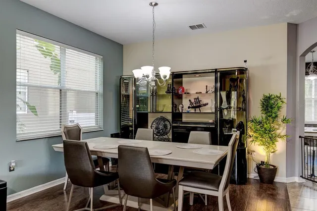 a view of a dining room with furniture window and wooden floor