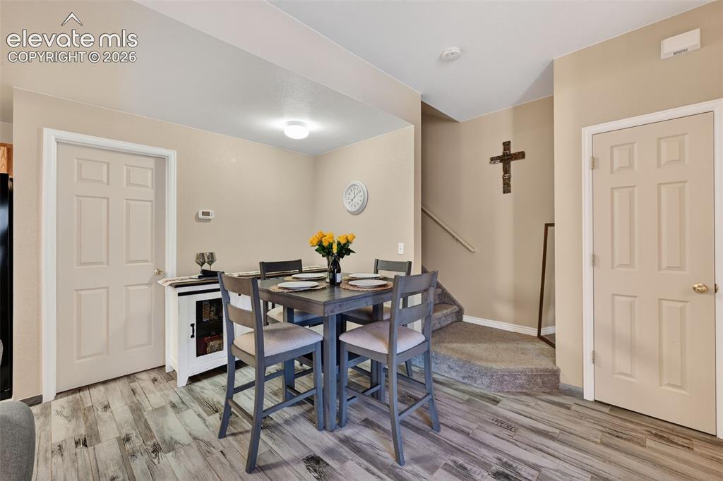 2141 Legacy Ridge View, Unit 109 Colorado Springs, CO 80910 - Photo 6 of 23 a view of a dining room with furniture and wooden floor