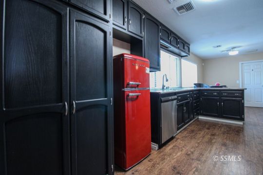 900 North Sierra View Street Ridgecrest, CA 93555 - Photo 11 of 42 a kitchen with stainless steel appliances a refrigerator and a sink