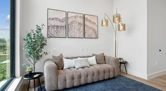 a living room with furniture and a potted plant