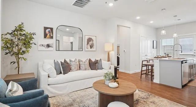 a living room with furniture and wooden floor
