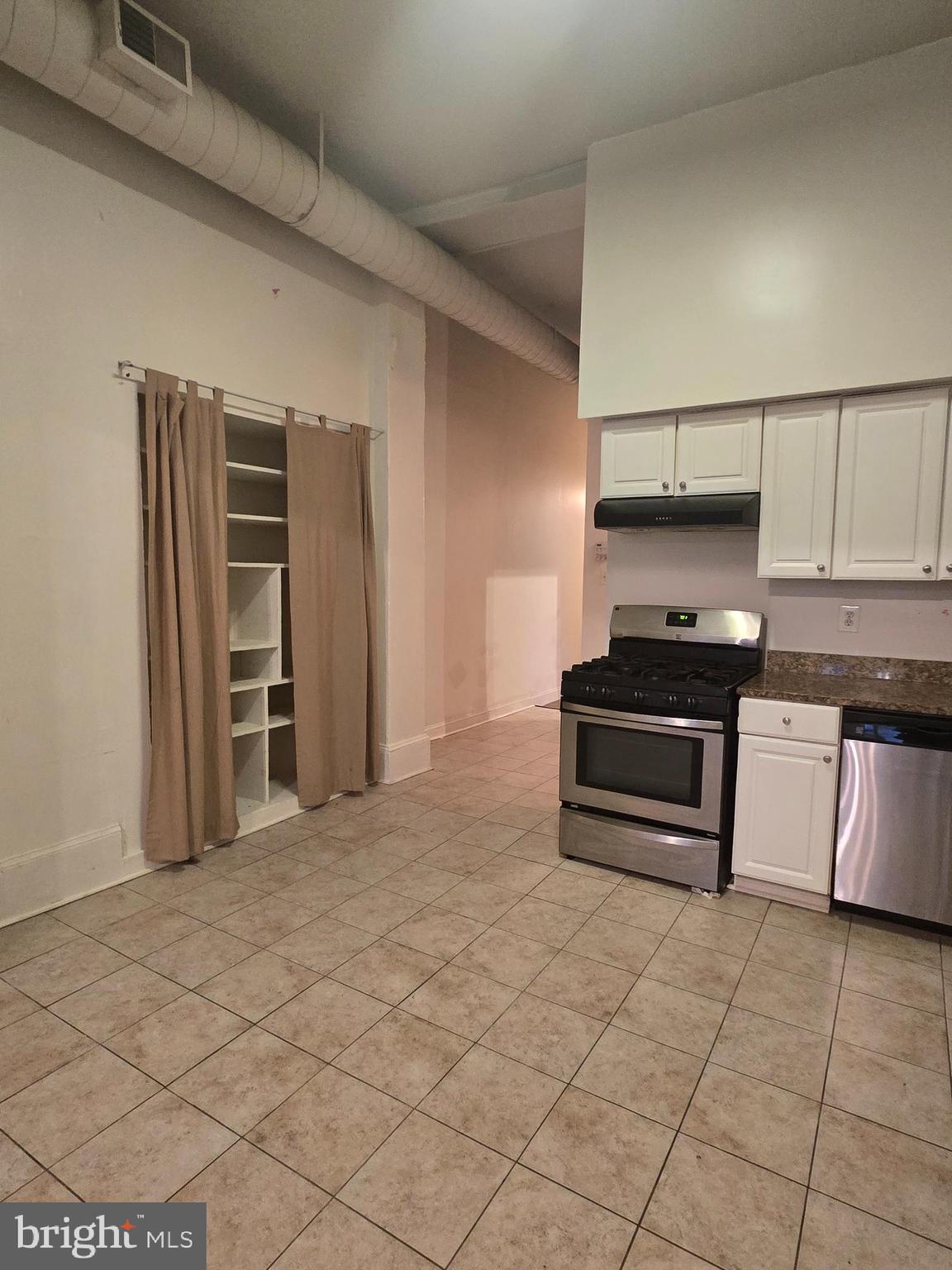 1304 Walnut Street, Unit 2 Philadelphia, PA 19107 - Photo 13 of 33 a kitchen with stainless steel appliances a stove and refrigerator