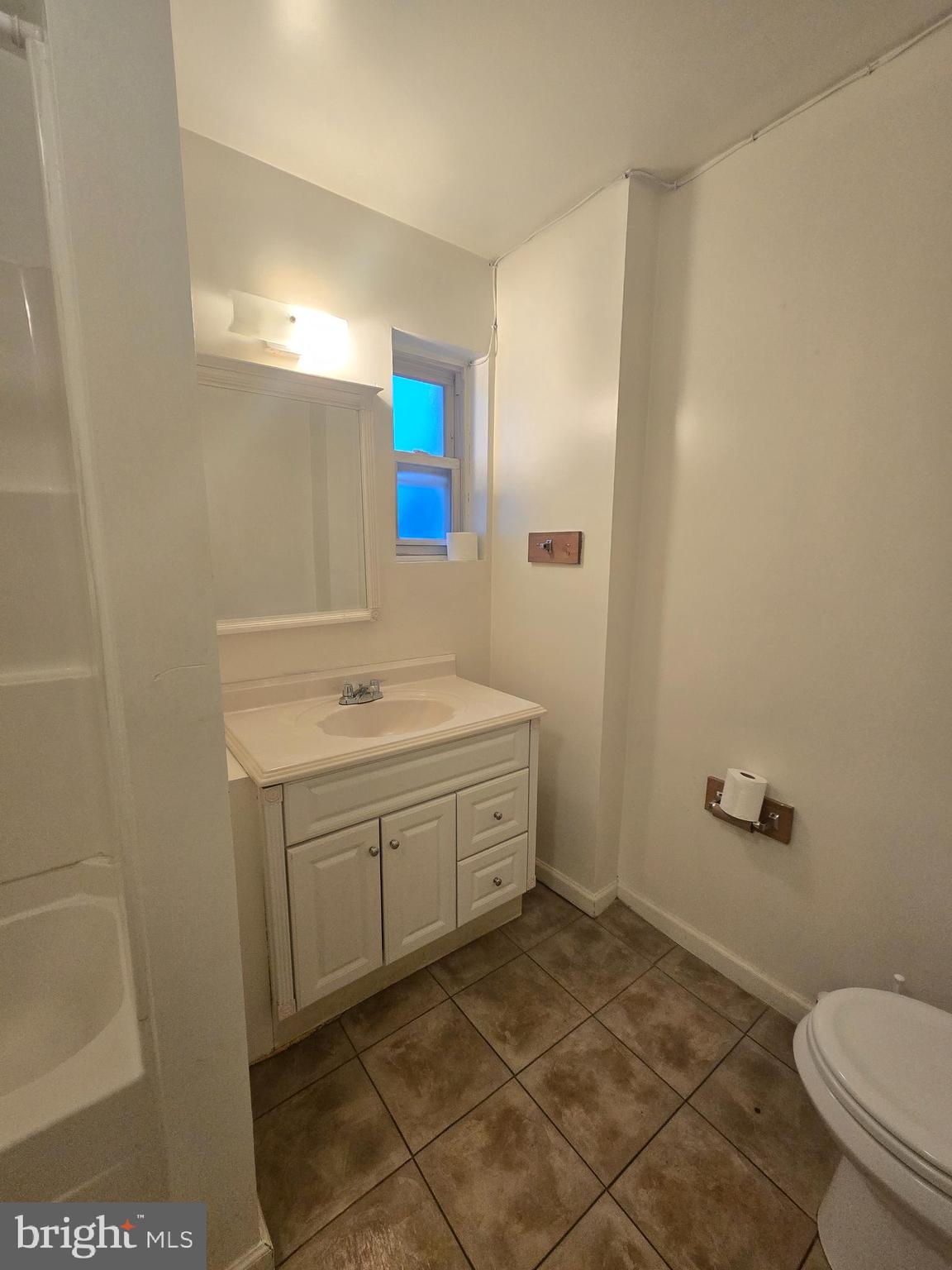 1304 Walnut Street, Unit 2 Philadelphia, PA 19107 - Photo 16 of 33 a bathroom with a granite countertop sink and a mirror
