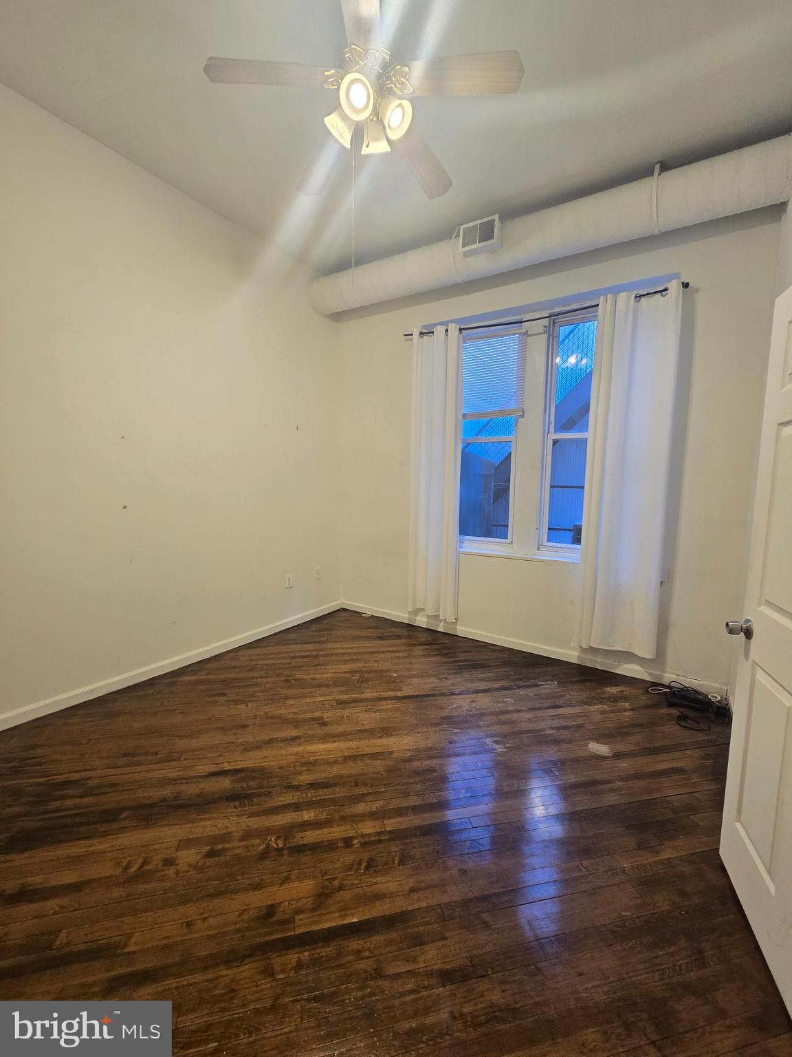 1304 Walnut Street, Unit 2 Philadelphia, PA 19107 - Photo 19 of 33 a view of an empty room with wooden floor and fan