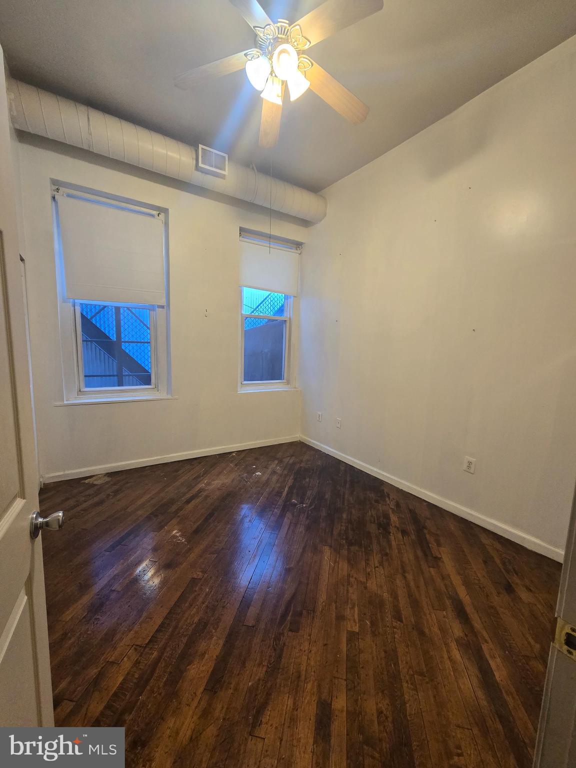 1304 Walnut Street, Unit 2 Philadelphia, PA 19107 - Photo 21 of 33 wooden floor in an empty room with a window
