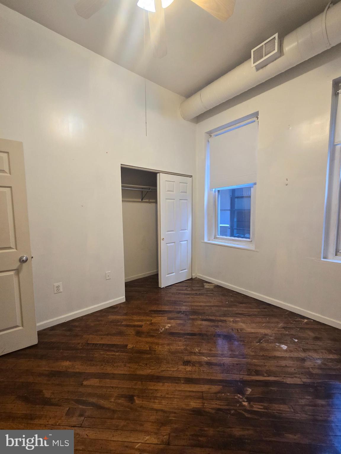 1304 Walnut Street, Unit 2 Philadelphia, PA 19107 - Photo 22 of 33 a view of an empty room with wooden floor and a window