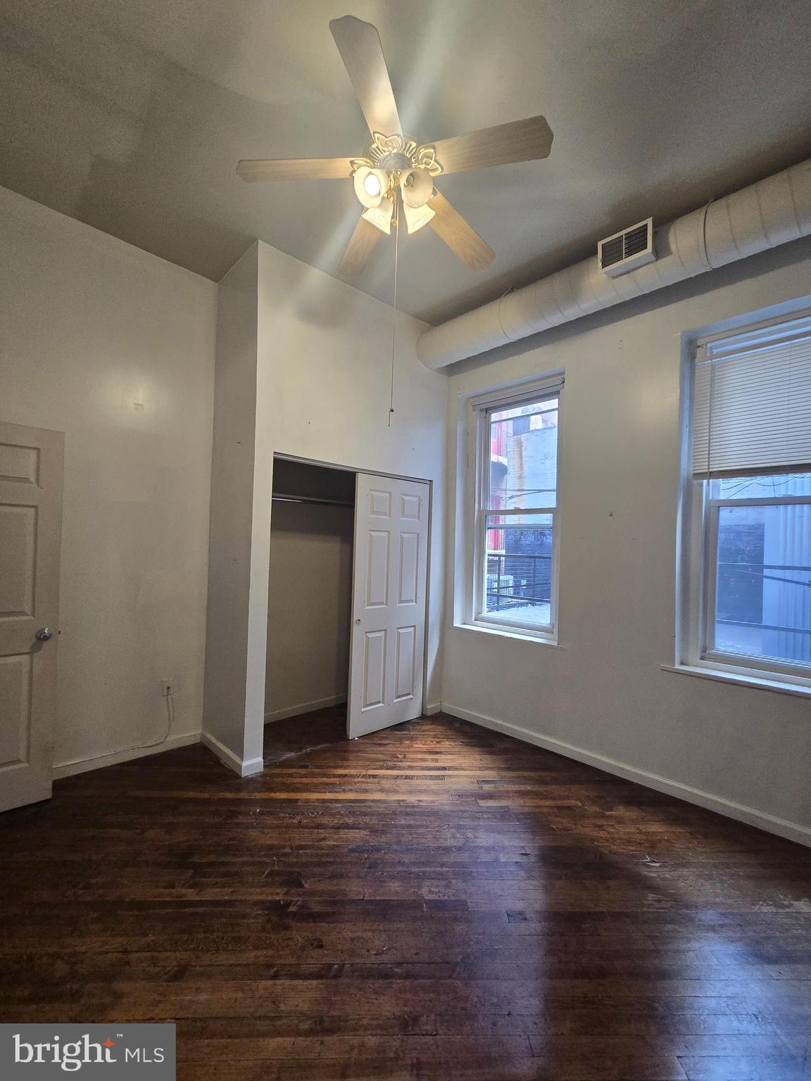 1304 Walnut Street, Unit 2 Philadelphia, PA 19107 - Photo 26 of 33 a view of an empty room with wooden floor and a window