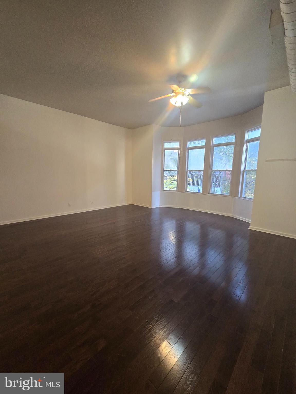 1304 Walnut Street, Unit 2 Philadelphia, PA 19107 - Photo 6 of 33 a view of an empty room with wooden floor and a window
