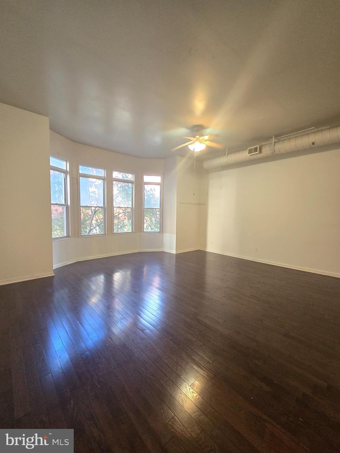 1304 Walnut Street, Unit 2 Philadelphia, PA 19107 - Photo 7 of 33 a view of an empty room with wooden floor and a window