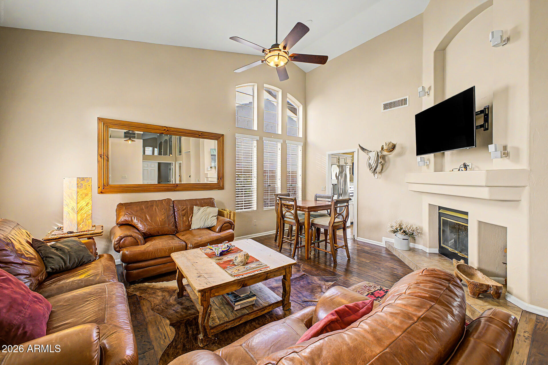 4309 East Rancho Caliente Drive Cave Creek, AZ 85331 - Photo 5 of 37 a living room with furniture a fireplace and a flat screen tv