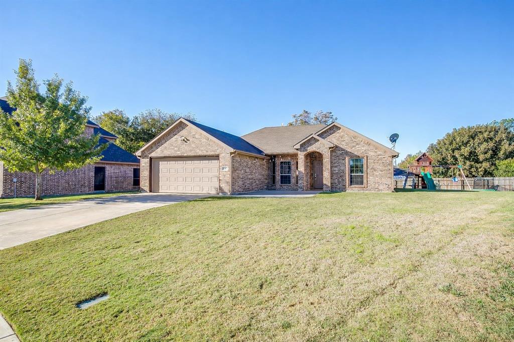 a view of a house with a yard and garage