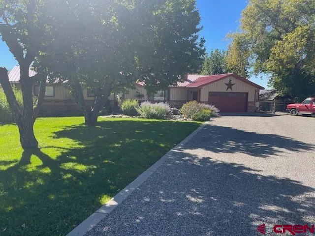 a view of an outdoor dining space with a table and chairs