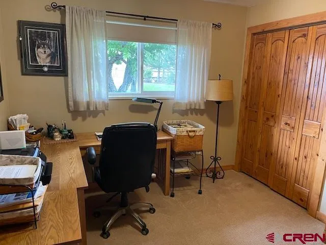 a large bed sitting in a bedroom next to a window