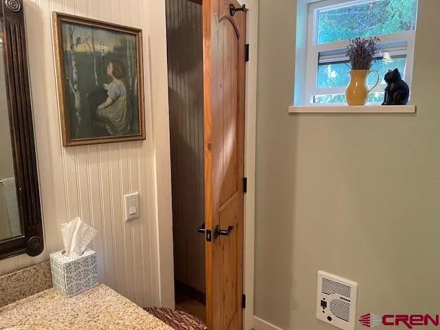 a bathroom with a granite countertop shower and a toilet