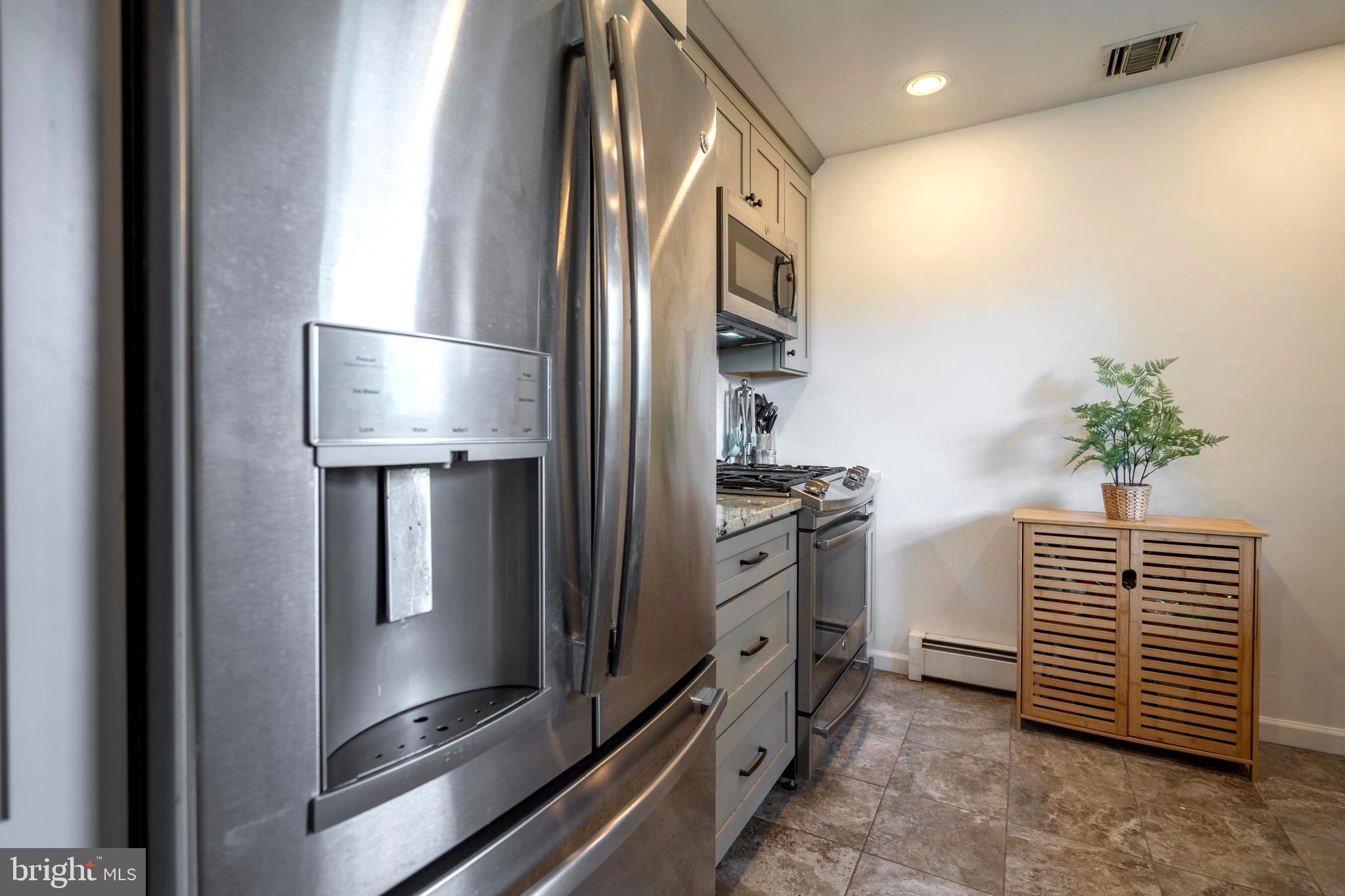 1066 Almshouse Road Ivyland, PA 18974 - Photo 12 of 39 a kitchen with white cabinets and stainless steel appliances