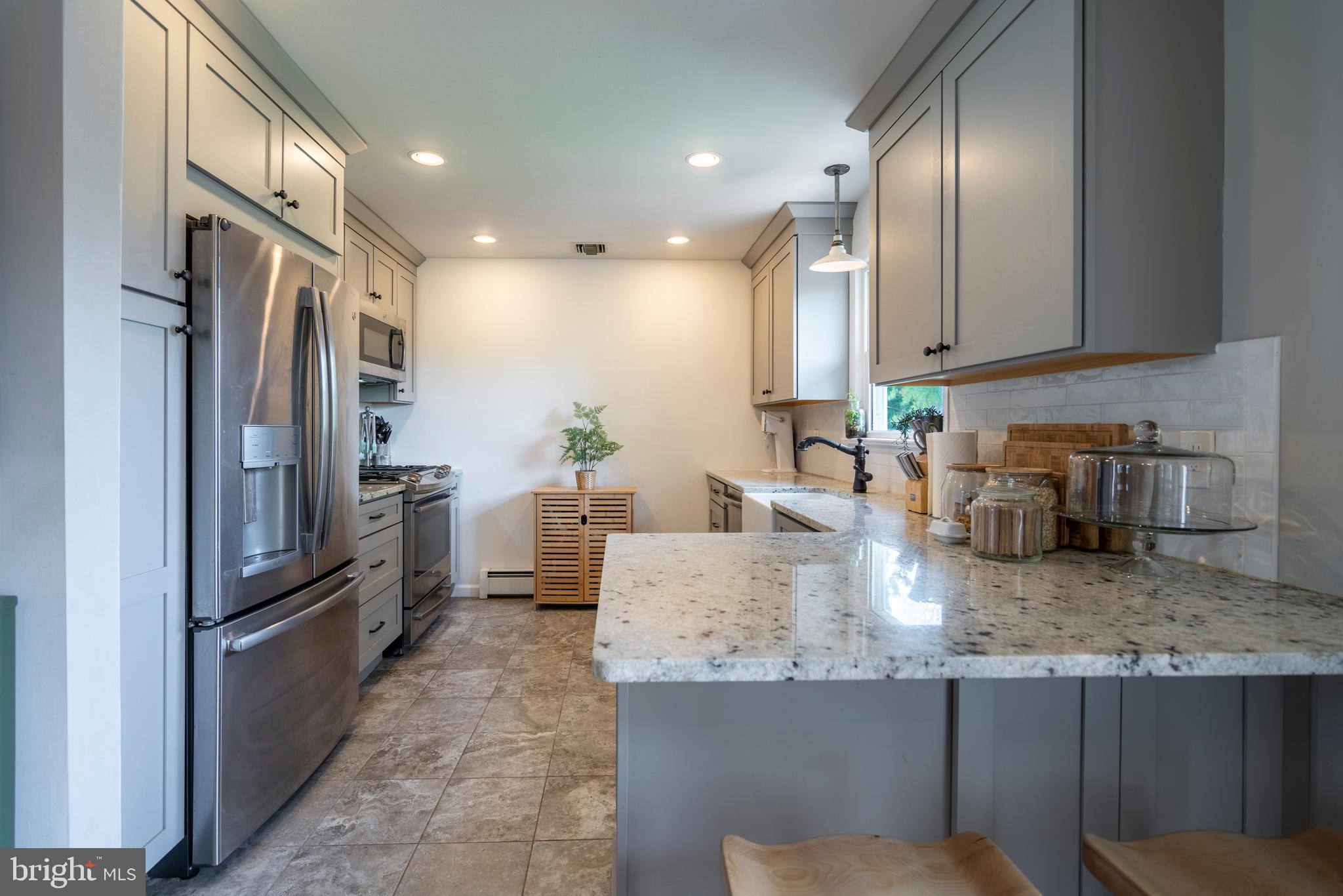 1066 Almshouse Road Ivyland, PA 18974 - Photo 14 of 39 a kitchen with granite countertop a refrigerator oven a sink dishwasher and cabinets