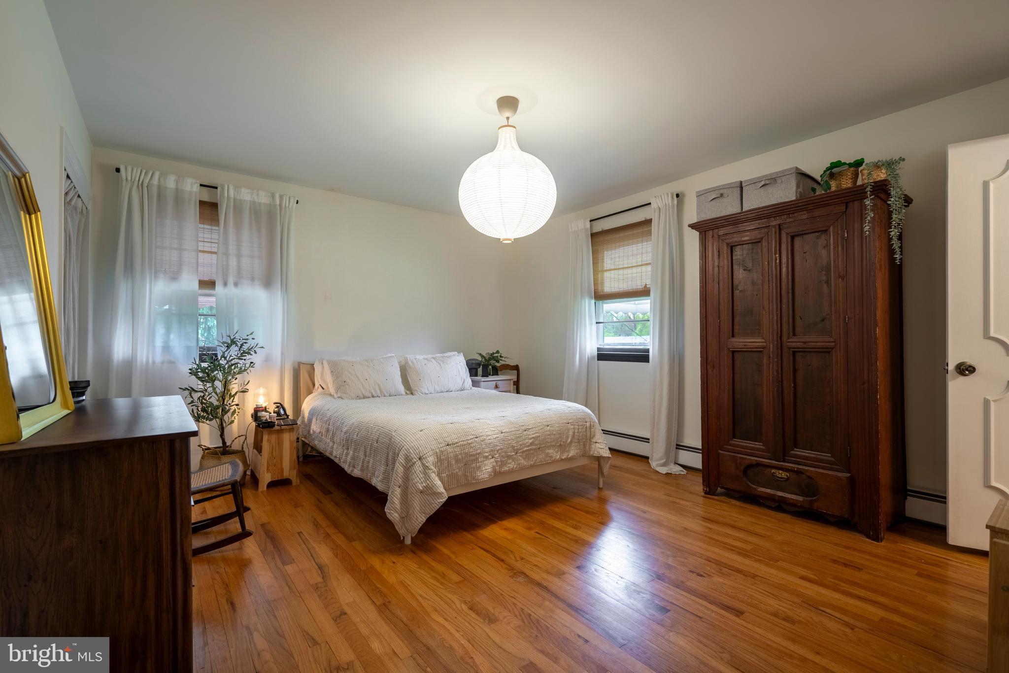 1066 Almshouse Road Ivyland, PA 18974 - Photo 22 of 39 a bedroom with a bed and wooden floor