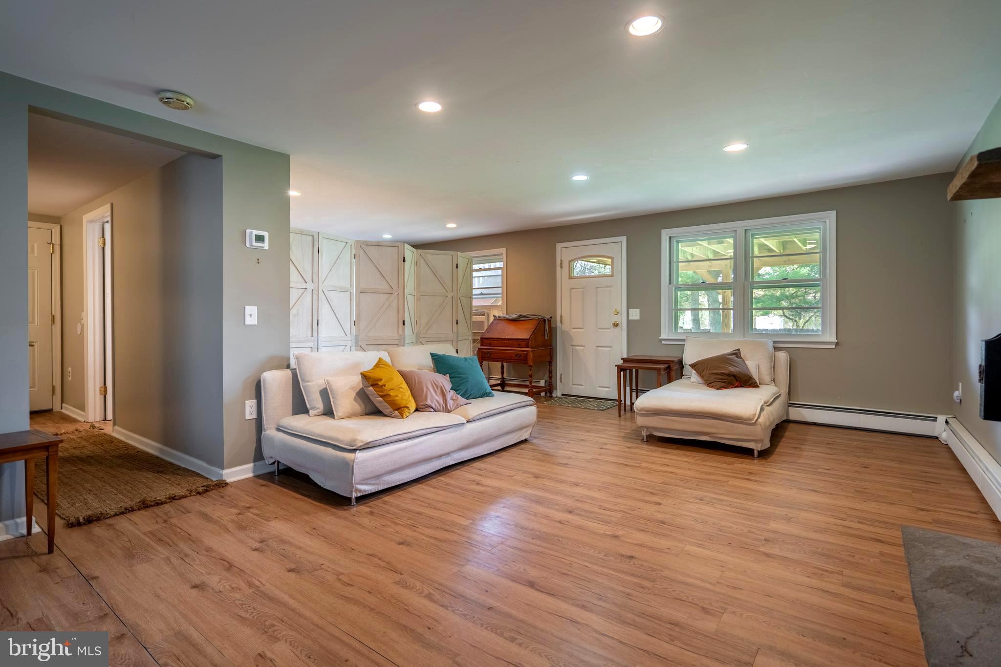 1066 Almshouse Road Ivyland, PA 18974 - Photo 26 of 39 a living room with furniture and a wooden floor