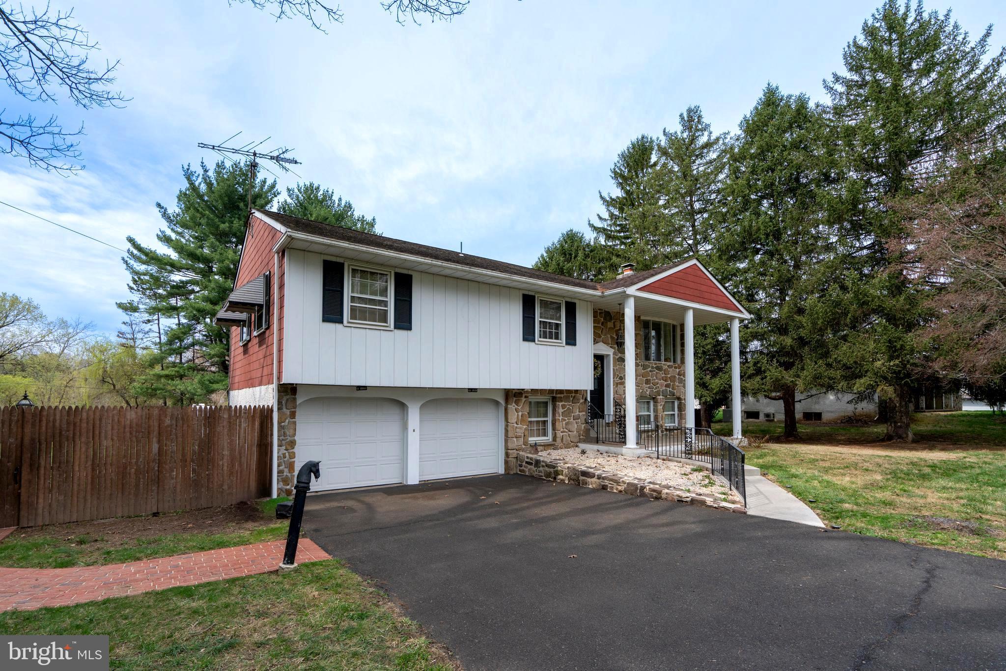 1066 Almshouse Road Ivyland, PA 18974 - Photo 3 of 39 a front view of a house with a yard and garage