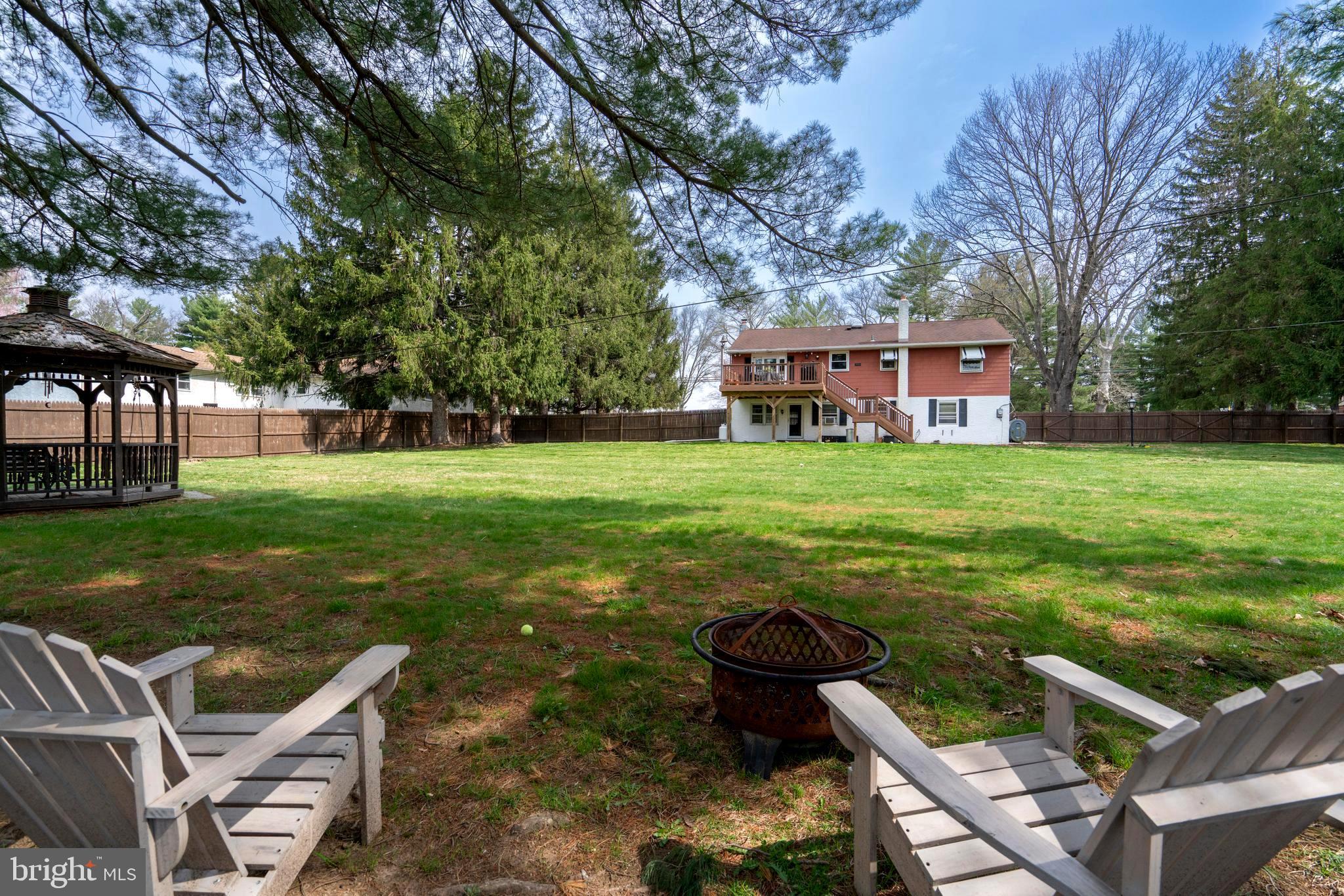 1066 Almshouse Road Ivyland, PA 18974 - Photo 38 of 39 a view of a backyard with table and chairs and a yard