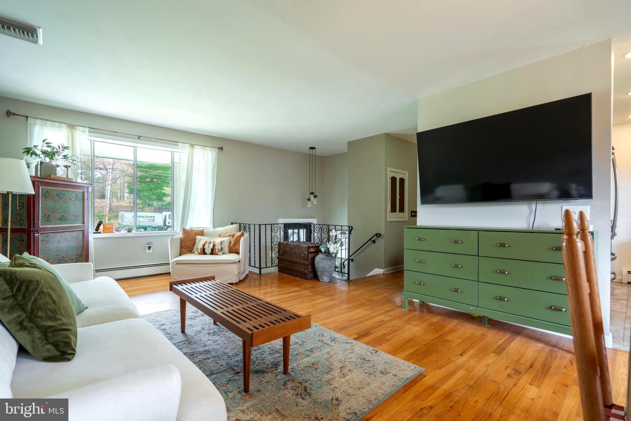 1066 Almshouse Road Ivyland, PA 18974 - Photo 6 of 39 a living room with furniture and a flat screen tv