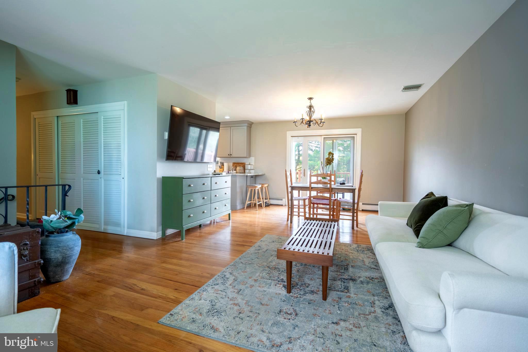 1066 Almshouse Road Ivyland, PA 18974 - Photo 7 of 39 a living room with furniture and a wooden floor