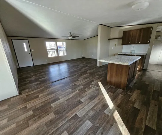 a kitchen with wooden floors and wooden cabinets