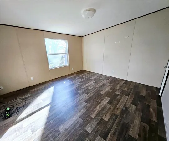 a view of a room with wooden floor