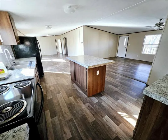 a kitchen with stainless steel appliances granite countertop a stove and a sink