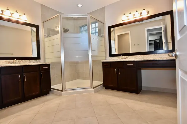 a bathroom with a sink a mirror and a shower