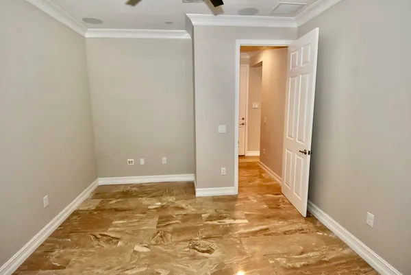 a view of a room with wooden floor and a window