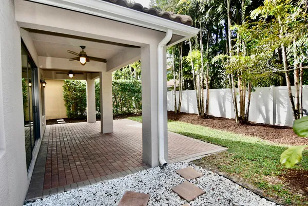 a porch with a table and chairs in front of it