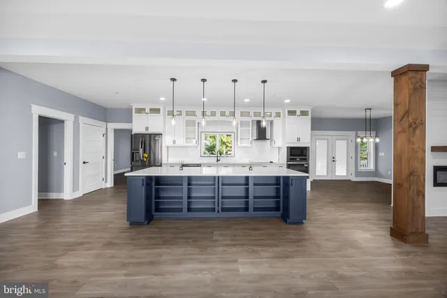 a large kitchen with stainless steel appliances kitchen island granite countertop a large counter top and sink