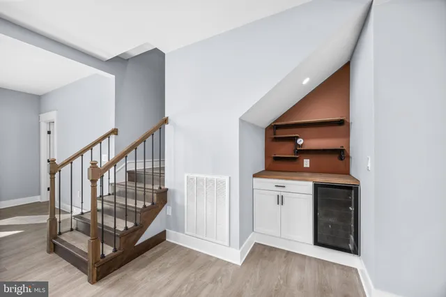a large kitchen with stainless steel appliances sink a stove and cabinets