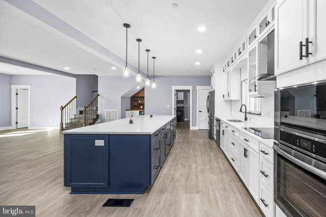 a view of room with walk in closet and wooden floor