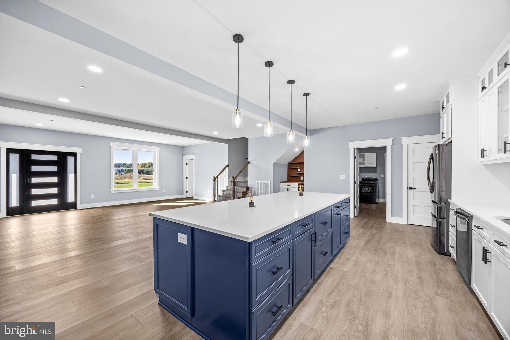 5692 King Stuart Drive Salisbury, MD 21801 - Photo 20 of 82 a large kitchen with kitchen island a stove a sink a center island and wooden floor