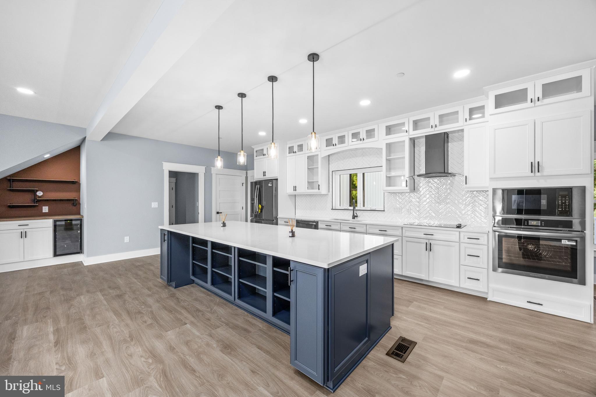 5692 King Stuart Drive Salisbury, MD 21801 - Photo 21 of 82 a large kitchen with stainless steel appliances sink a stove and cabinets