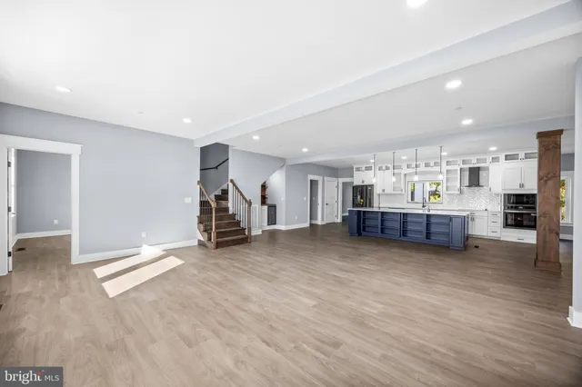 a bathroom with a granite countertop shower sink and mirror